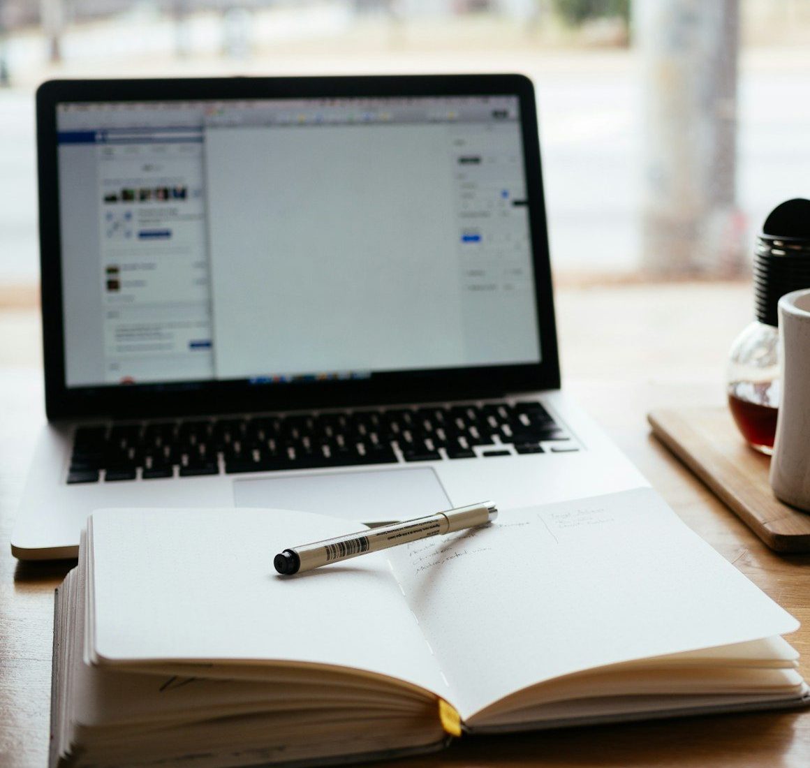 MacBook Pro near white open book